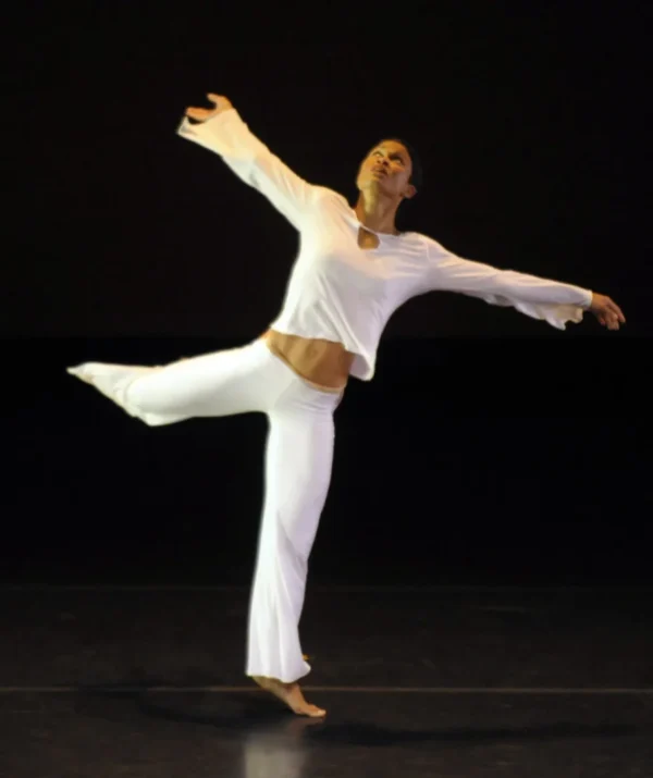 A dancer in white in arabesque
