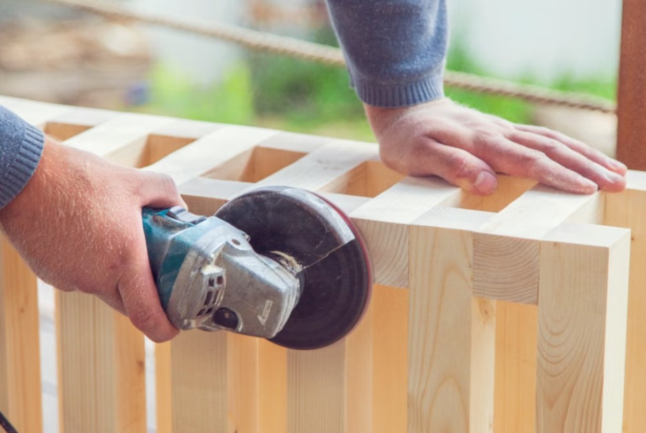 CD-surfprep-air-sander-Insert1 Hands using an electric sander on a wooden frame