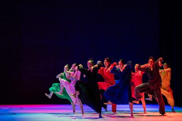 Dancers in multi-colored costumes