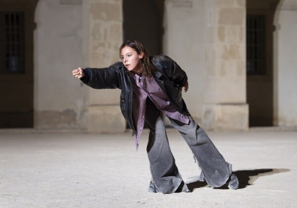 Dancer lunges in street clothes