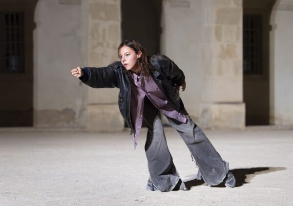 Dancer lunges in street clothes