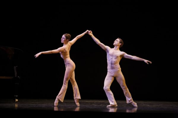 A male dancer supports a female dancer