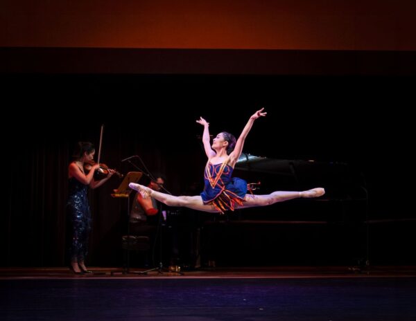 A dancer leaps in the splits